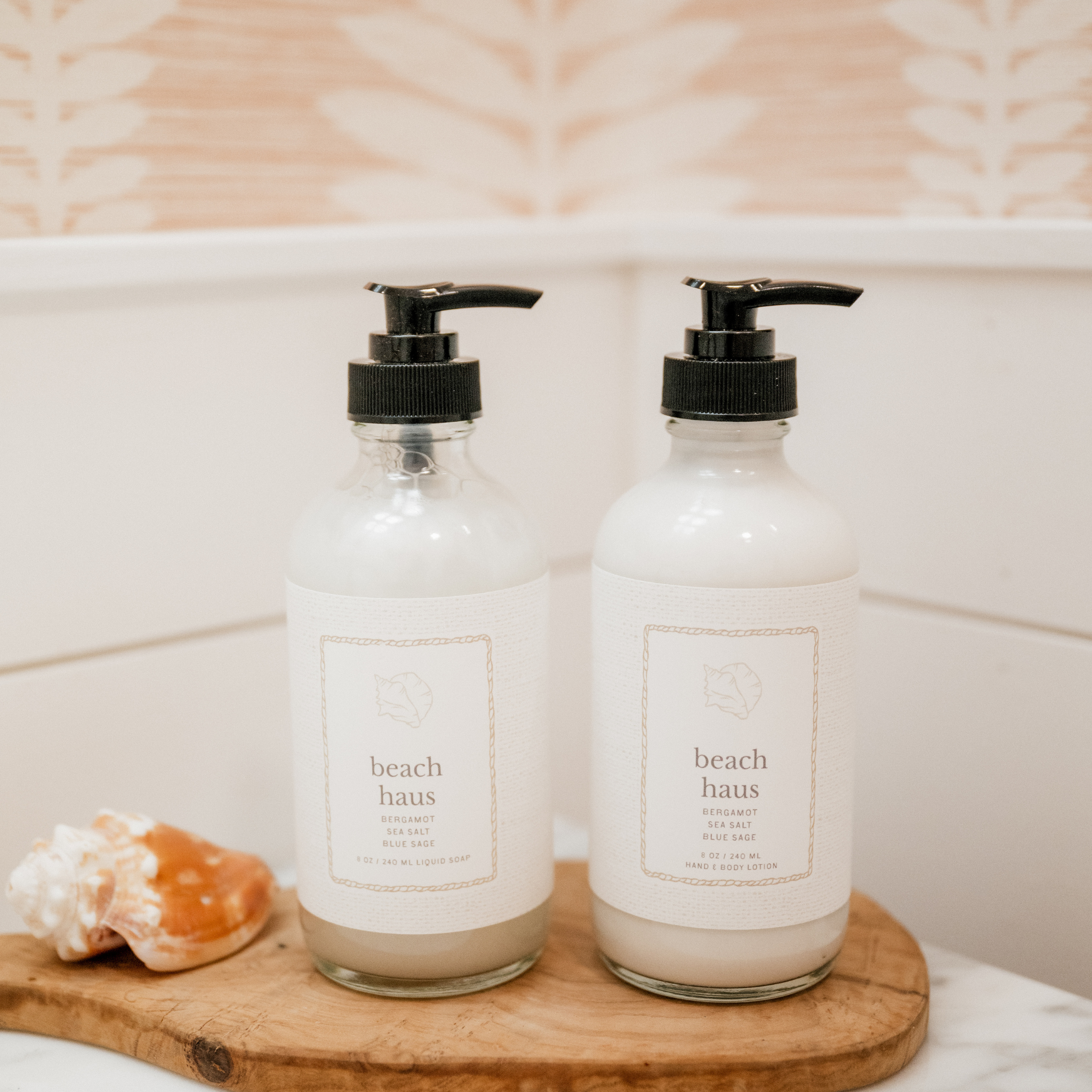 Two glass bottles with black pumps labeled &