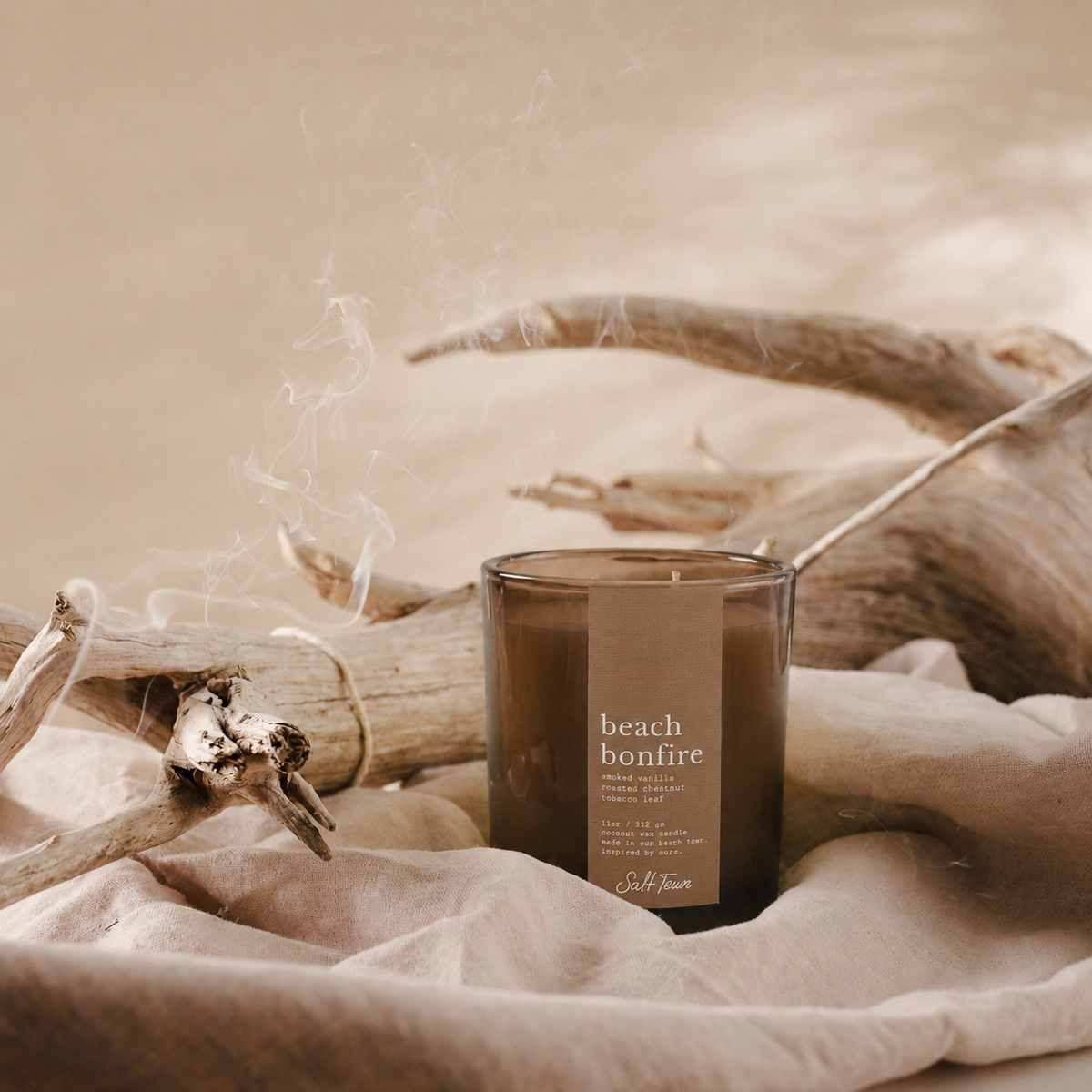 A smoky amber glass candle jar labeled &